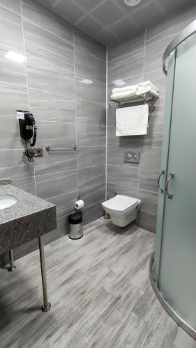 a bathroom with a toilet and a sink and a shower at MİLLS HOTEL in Tekirdag