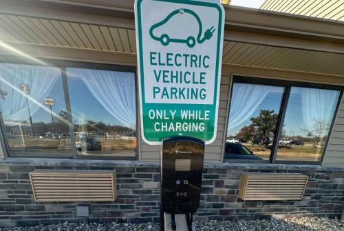 a parking meter with a parking sign in front of a building at Baymont by Wyndham Perrysburg-Toledo in Perrysburg