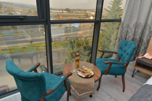 a room with two chairs and a table with a bottle of beer at MİLLS HOTEL in Tekirdag
