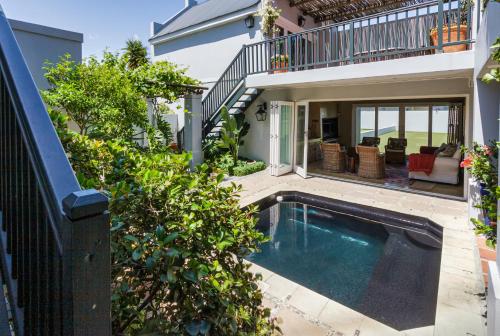 a swimming pool in the backyard of a house at Strand Beach Lodge in Strand
