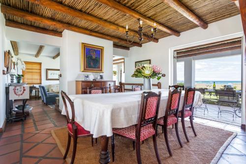 a dining room with a table and chairs at Strand Beach Lodge in Strand