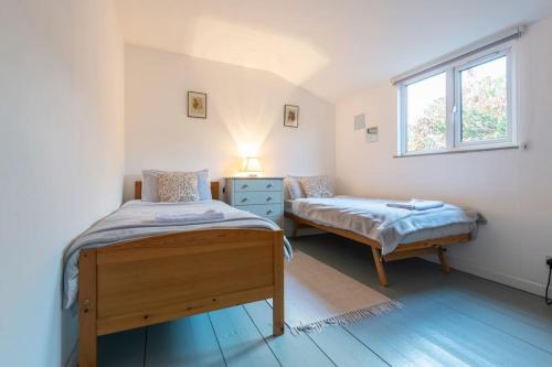 a bedroom with two beds and a window at The Chalet in Fort Augustus