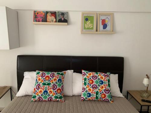 a bedroom with a bed with two pillows on it at Albero di giada in Massafra