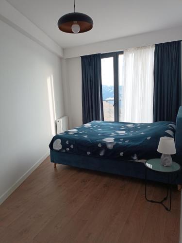 a bedroom with a bed and a large window at Apartment with a great view 544 in Gudauri