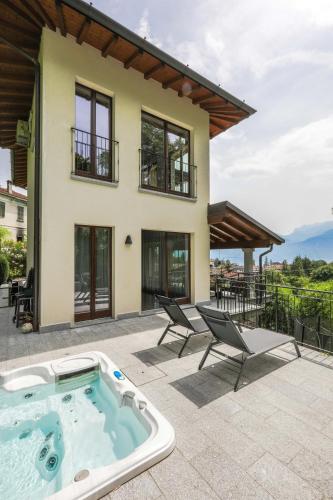 a house with a hot tub on a patio at Villa Elena in Menaggio