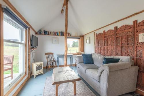 a living room with a couch and a table at The Field House in Fort Augustus