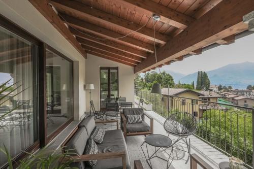 a patio with a couch and chairs on a balcony at Villa Elena in Menaggio