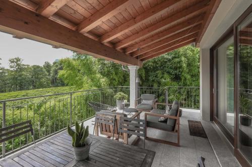 a patio with a table and chairs on a deck at Villa Elena in Menaggio