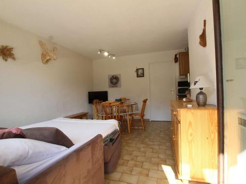 une chambre avec un lit et une cuisine avec une table dans l'établissement Studio familial à Serre-Chevalier, Chantemerle, avec terrasse et Wi-Fi en option, 4 pers - FR-1-330E-121, à Saint-Chaffrey