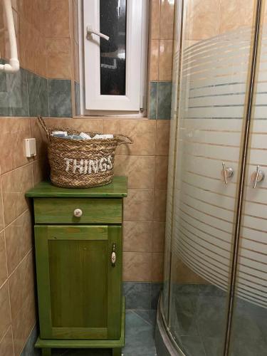 a bathroom with a green cabinet and a shower at Sunny Hill kuća za odmor na Zlataru in Vukovina