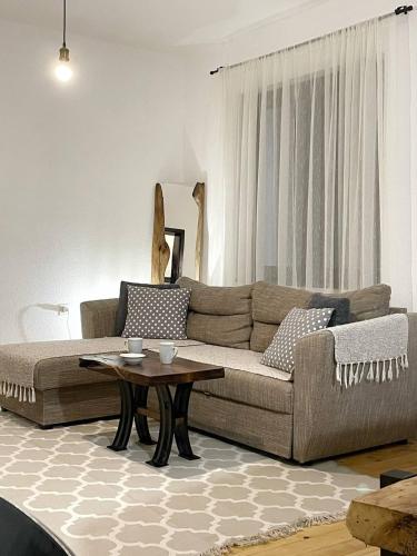 a living room with a couch and a table at Sunny Hill kuća za odmor na Zlataru in Vukovina