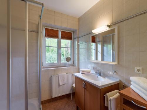 a bathroom with a sink and a shower at Landhaus Maximilian in Hopfgarten im Brixental