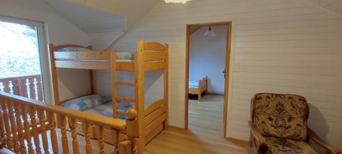 a room with two bunk beds in a house at Domek na Malinowej in Szczyrk