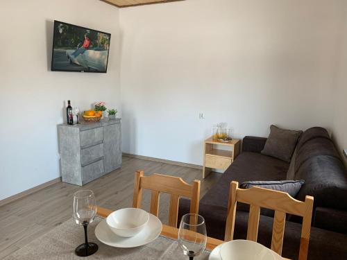 a living room with a couch and a table with chairs at Na wilczym szlaku in Ustrzyki Dolne
