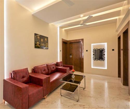 a living room with a couch and a table at Hotel Rose Gold in Ahmadnagar