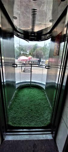a window in a building with a green floor at Hotel Rose Gold in Ahmadnagar