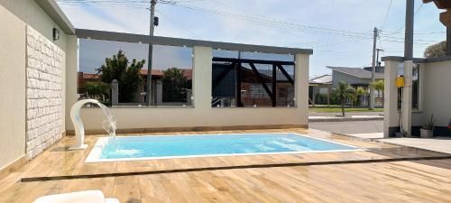 Πισίνα στο ή κοντά στο Casa Com Piscina Pertinho Do Mar Em Capão Da Canoa