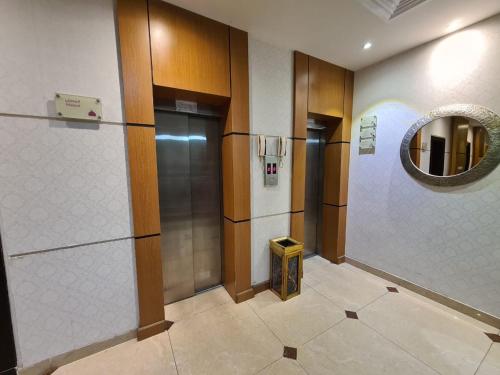 a elevator in a building with a mirror at تـالـيـن الـهـفـوف in Al Hofuf