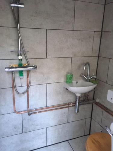 a bathroom with a sink and a shower at Surfers and walkers cosy camping cabin in Ilfracombe