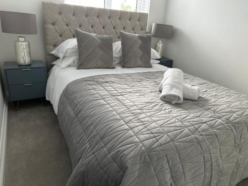 a bedroom with a large bed with towels on it at Stunning City Centre Apartments in Cardiff