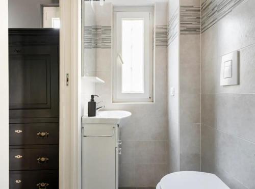a bathroom with a white toilet and a sink at Milan Emerald Home ''Wifi & Self Check-in'' in Milan