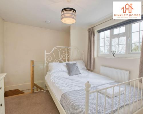 a bedroom with a white bed and a window at Cosy Contained Riverside 1bed - 2 Floors - Parking in Bridgwater