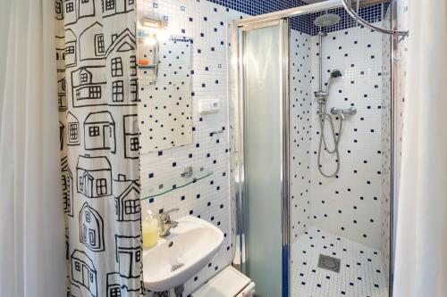 a bathroom with a sink and a shower at Sleep & Go Single Room in Prague