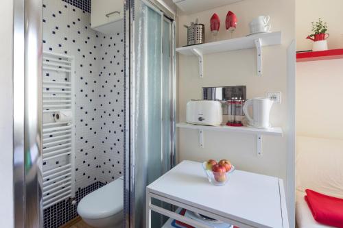 a bathroom with a shower and a toilet and a sink at Sleep & Go Single Room in Prague