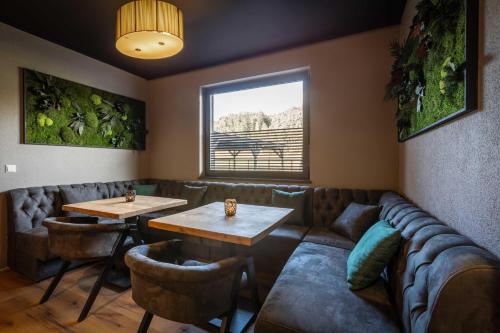 a restaurant with couches and tables and a couch at The Art and Sporthotel in Innsbruck