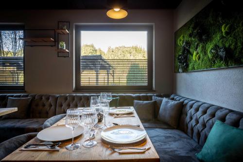 a dining room with a table with wine glasses at The Art and Sporthotel in Innsbruck