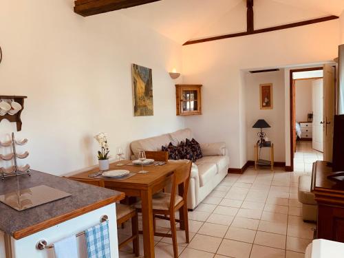 a living room with a table and a couch at La Sellerie at No 17 in Le Dorat