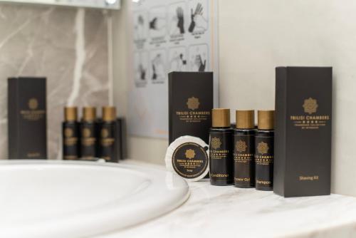 a group of five bottles of hair products on a counter at Tbilisi Chambers, Trademark Collection by Wyndham in Tbilisi City