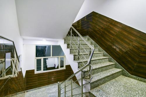 a staircase in a house with wooden walls at Hotel Pearl - Mahipalpur Delhi Airport in New Delhi