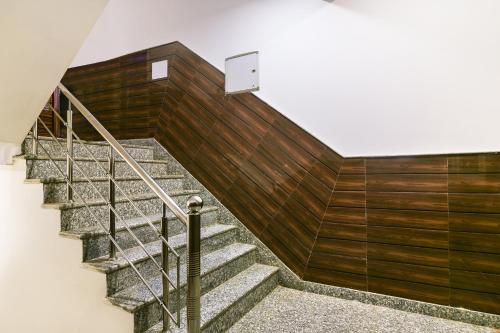 a staircase in a building with wood paneling at Hotel Pearl - Mahipalpur Delhi Airport in New Delhi