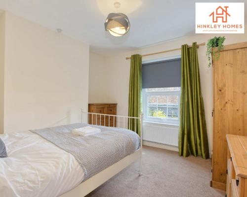 a bedroom with a bed and a window with green curtains at Centrally Tucked Away Private 4bed - Free parking! By Hinkley Homes Short Lets & Serviced Accommodation in Bridgwater