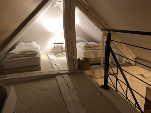 a attic room with two beds and a window at La Scellerie, le charme au cœur de Tours in Tours
