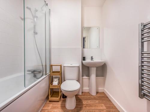 a bathroom with a toilet and a sink and a shower at Pass the Keys Central Modern Flat with Parking in Chichester