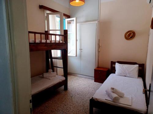 a bedroom with two bunk beds and a window at Big apartment on the beach in Tolo