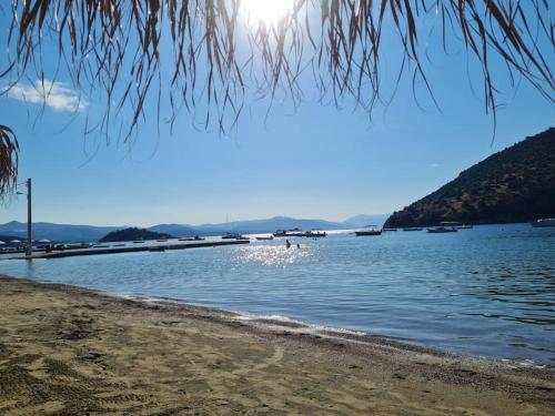 a view of a lake with boats in the water at Big apartment on the beach in Tolo