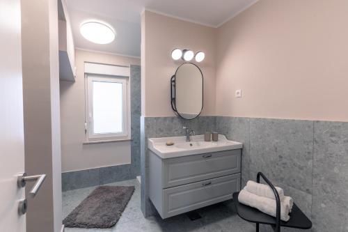 a bathroom with a sink and a mirror at Vila Valentina in Ljubljana
