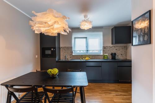 a kitchen and dining room with a table and chairs at Vila Valentina in Ljubljana