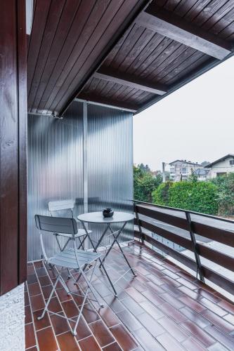 a patio with a table and chairs on a balcony at Vila Valentina in Ljubljana