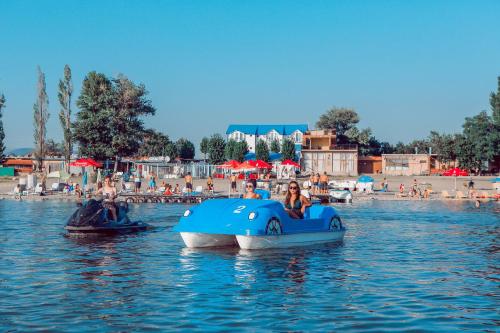 a group of people riding on a boat in the water at Laguna Villa - Pool, Sauna, Events - at Bazaleti Lake in Karsimaantkari