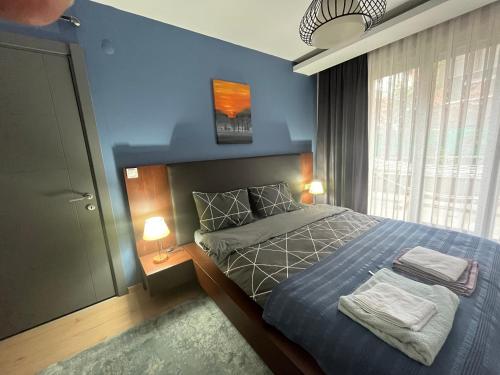 a bedroom with a bed with two towels on it at wide garden flat close to the memorıall hospital hGyhomes2103 in Istanbul