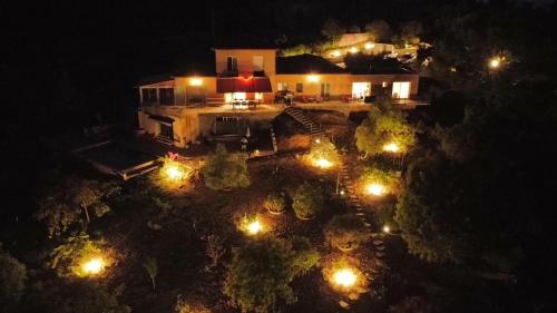 an aerial view of a house at night with lights at DOMAINE MAXXIM in Clermont-lʼHérault