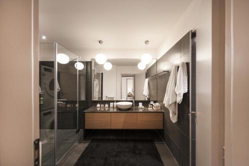 a bathroom with a sink and a shower at Kolonaki 2 Bdr apartment in Athens