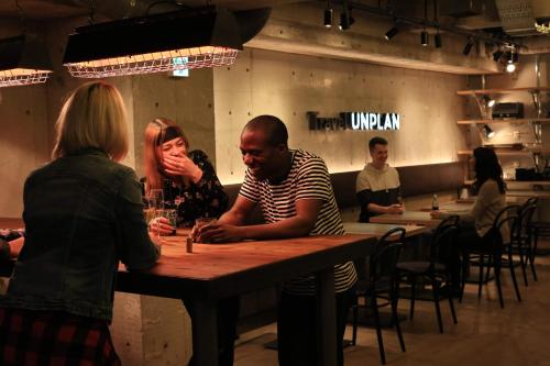 a group of people sitting at a table in a restaurant at UNPLAN Shinjuku in Tokyo
