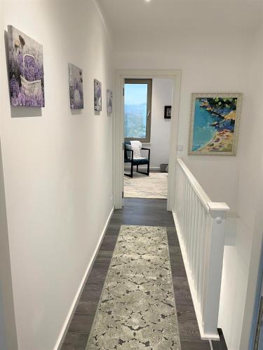 a hallway with paintings on the walls of a house at Duplex Seaview Condo in Durrës