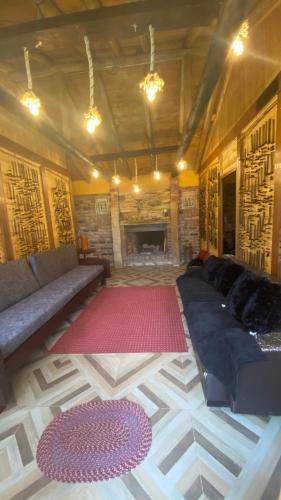 a living room with a couch and a fireplace at Chalet Amadeus Guatavita in Guatavita
