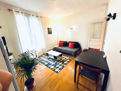 a living room with a couch and a table at Descent Unit in Fontainebleau in Fontainebleau